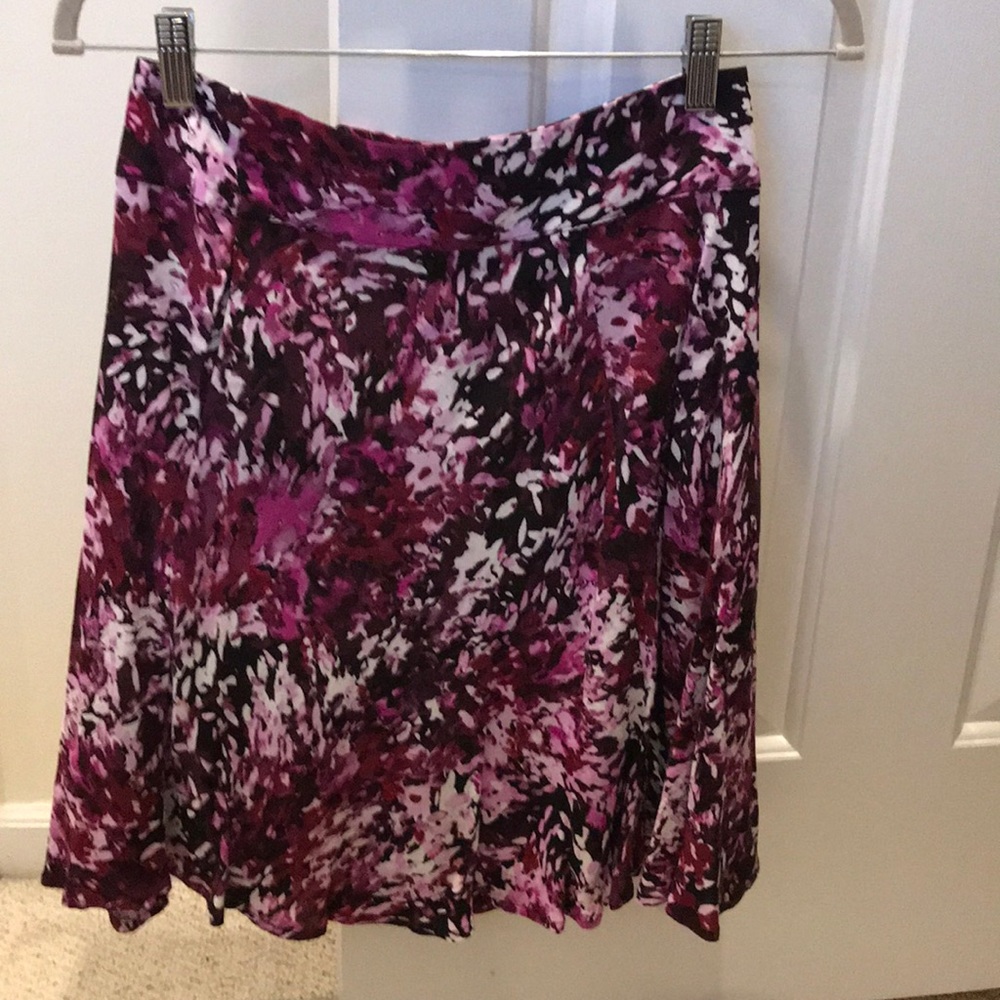 Full skirt, shades of pink, has matching blouse.
